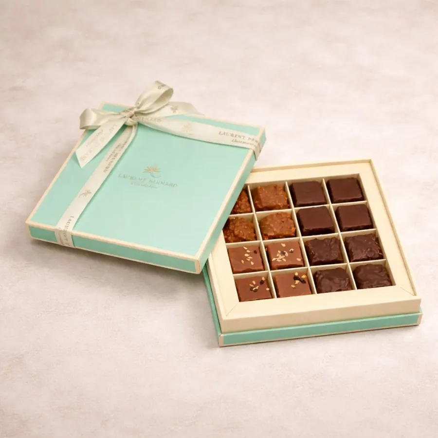 Open praline gift box with satin ribbon