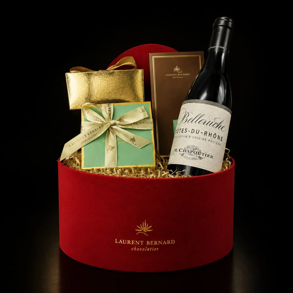 Luxury wine and chocolate gift hamper by Laurent Bernard with premium chocolates and fine wine in an elegant black setting.